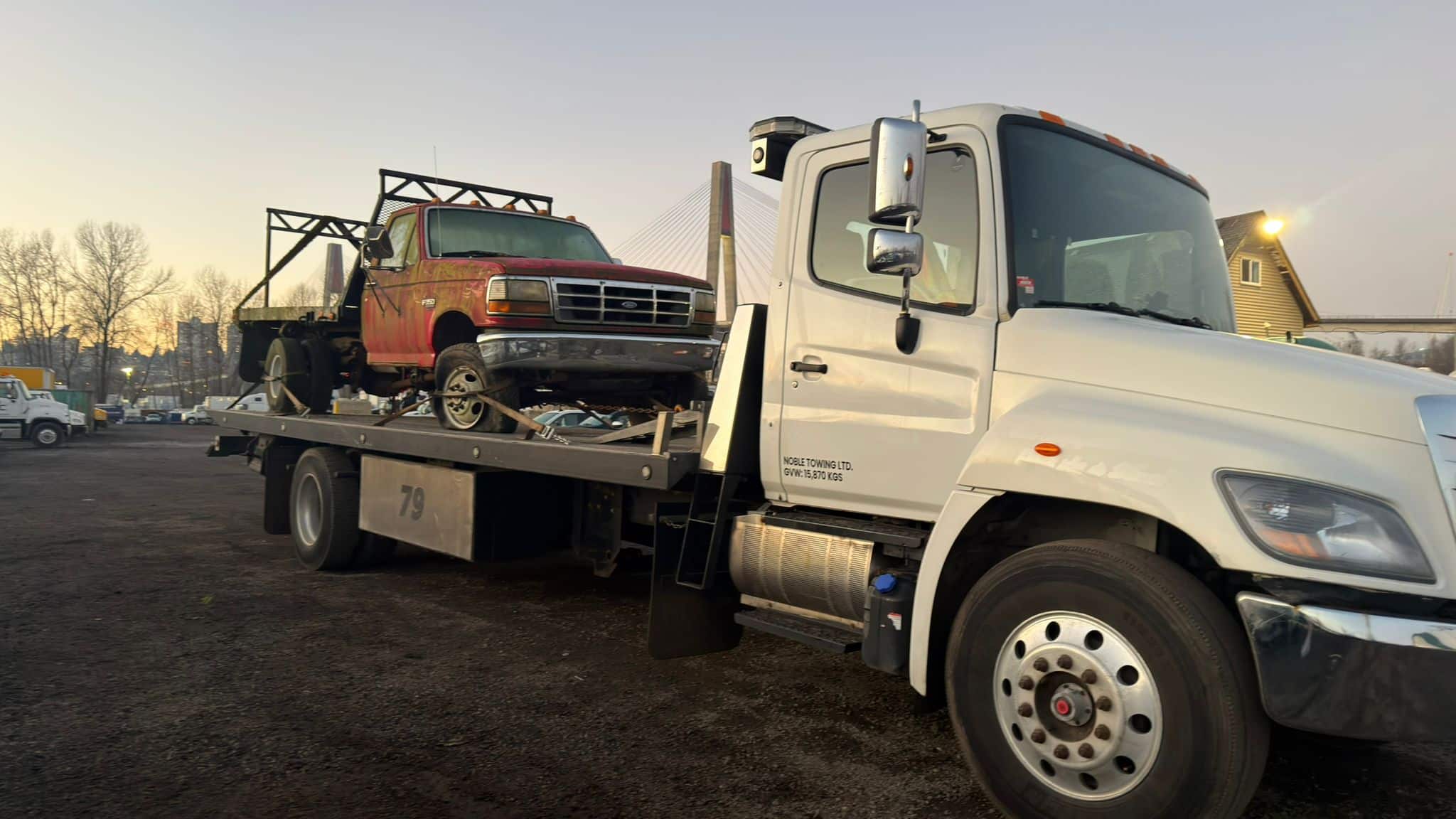 Car being hauled away for scrapping by Noble Towing