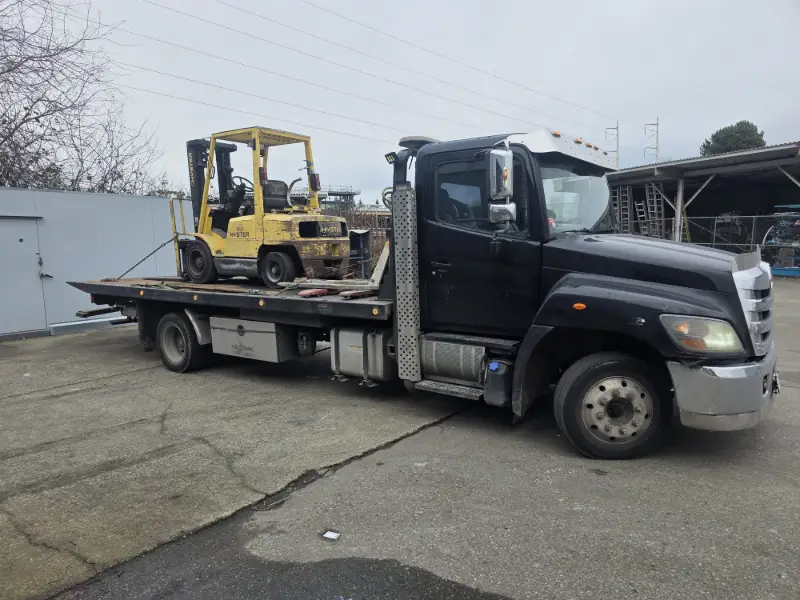 Non-running forklift being removed