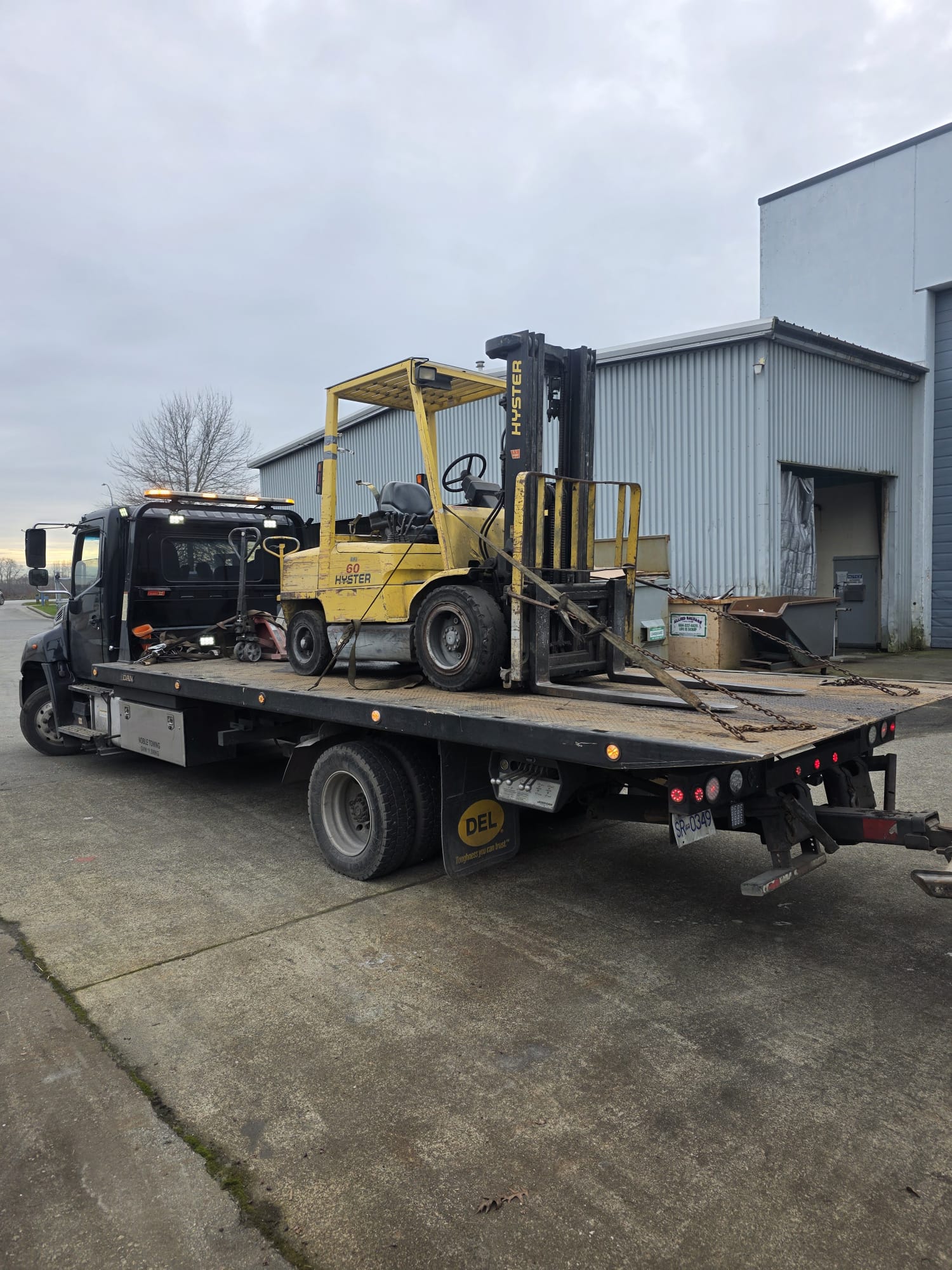 Scrap forklift being towed away